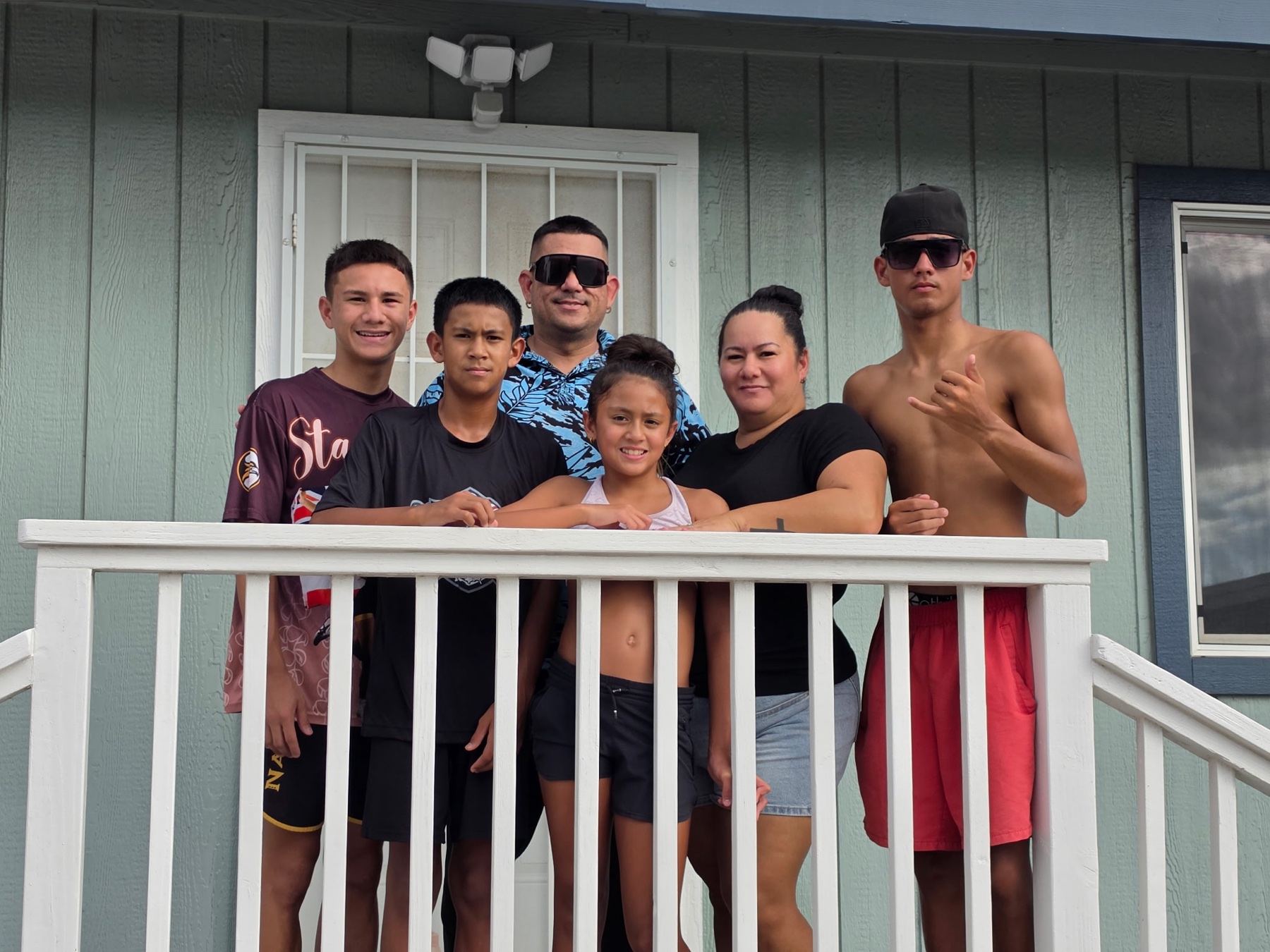 A family gathered together on the lanai of their Oʻahu home